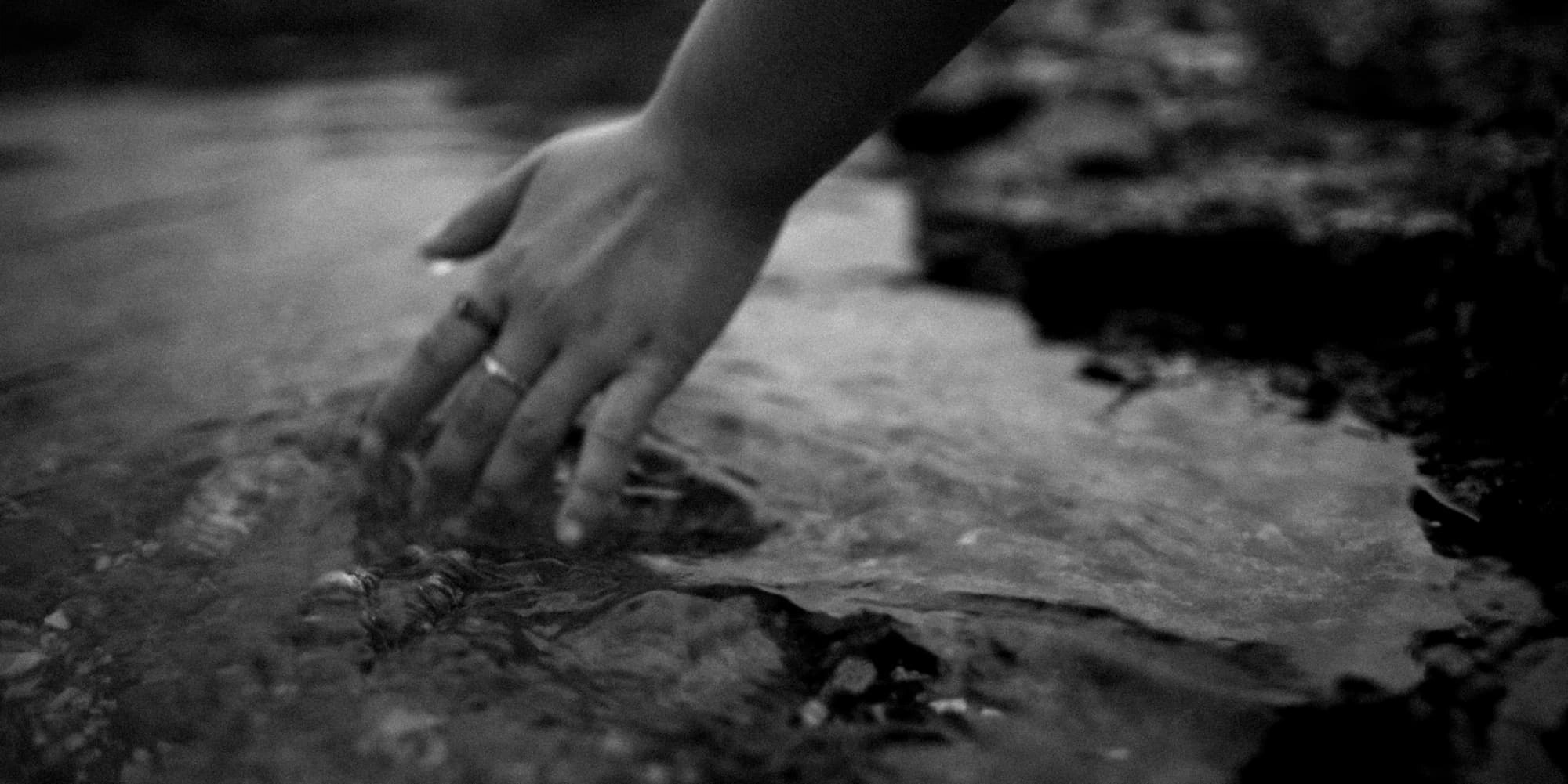 hand playing with water